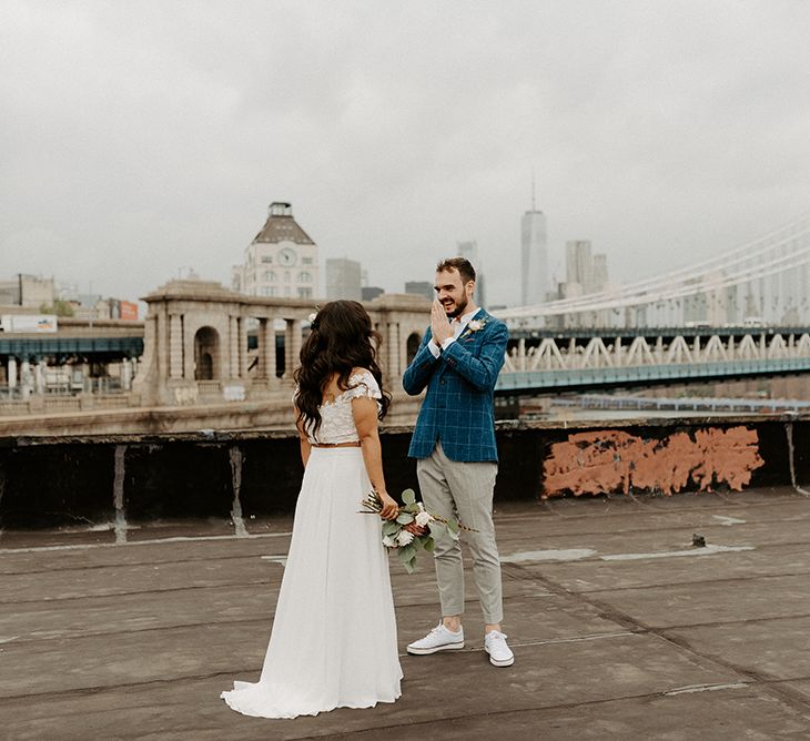 Bride and Groom first look moment on rooftop building with Manhattan skyline for Brooklyn elopement