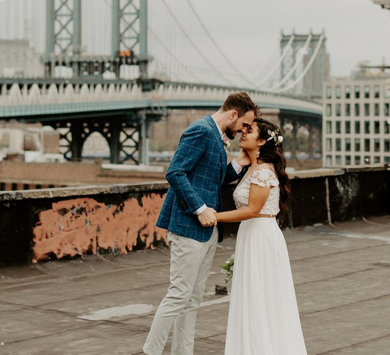 Bride and Groom first look moment on rooftop building with Manhattan skyline for Brooklyn elopement