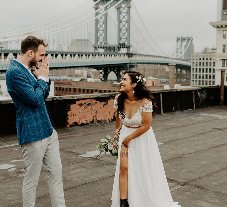 Bride and Groom first look moment on rooftop building with Manhattan skyline  and bridal boots