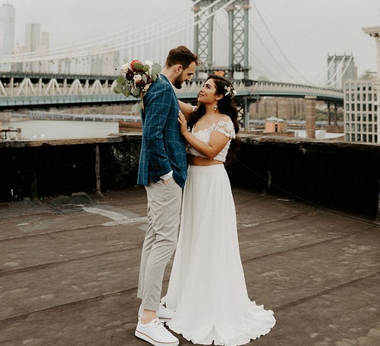 Bride and Groom first look moment on rooftop building with Manhattan skyline and bridal separates