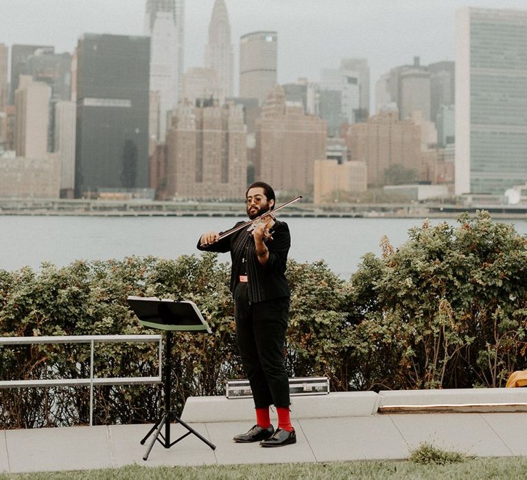 Violinist at Brooklyn elopement with NYC skyline backdrop