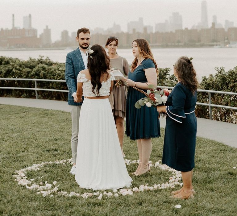 Bride and groom tie the knot at a park overlooking the East River and the NYC skyline