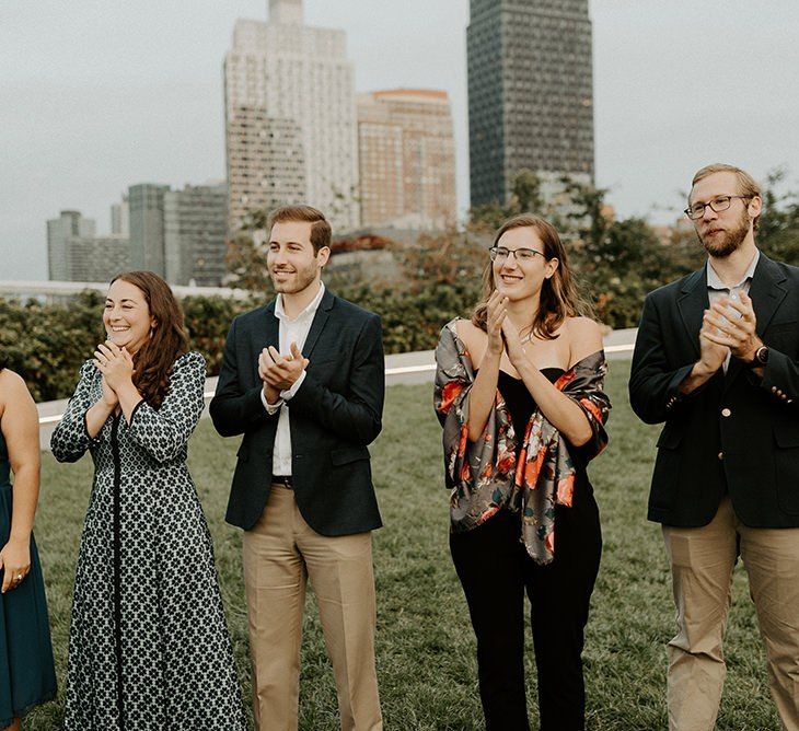 Guests enjoying Brooklyn elopement with NYC skyline backdrop