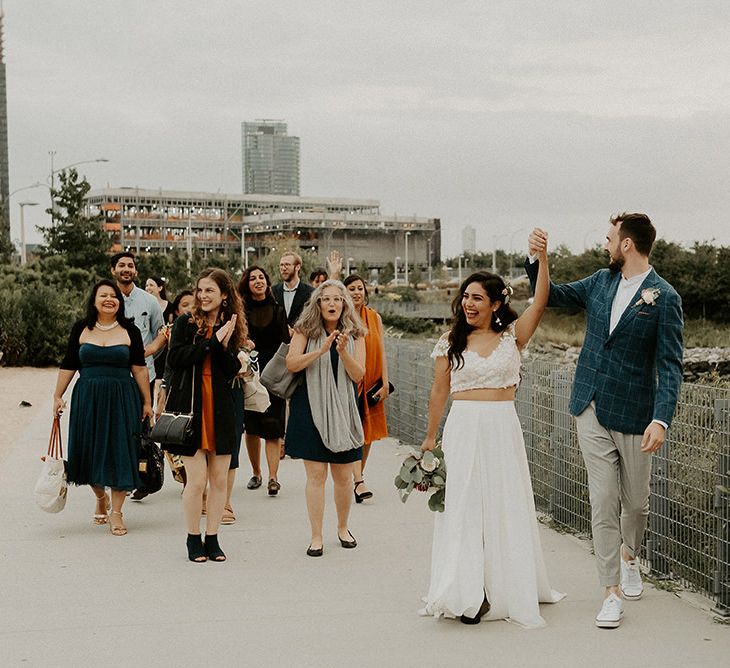 Bride and groom celebrate with their guests for Brooklyn elopement with NYC skyline backdrop