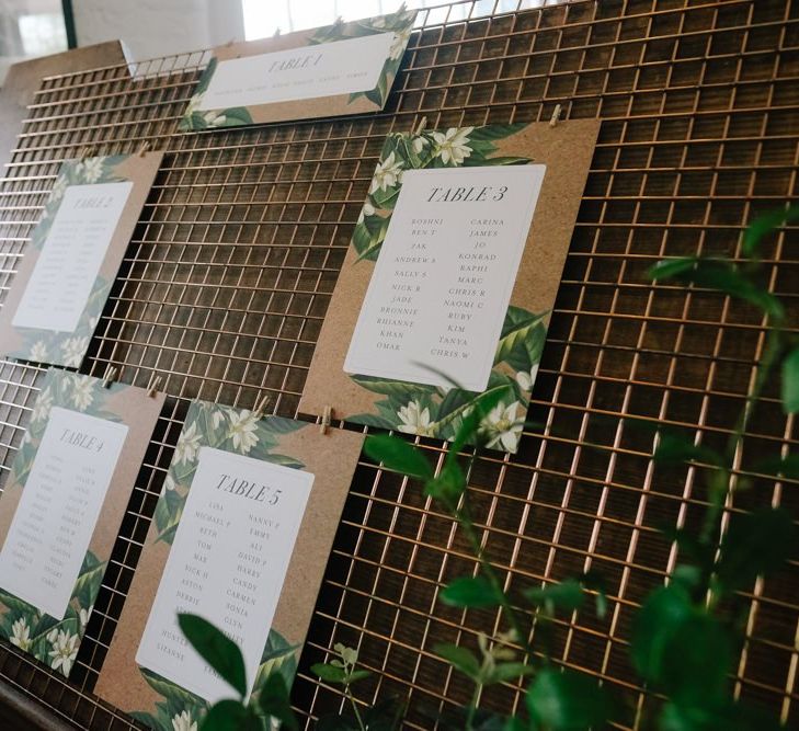 Wedding seating plan sign surrounded with foliage decor