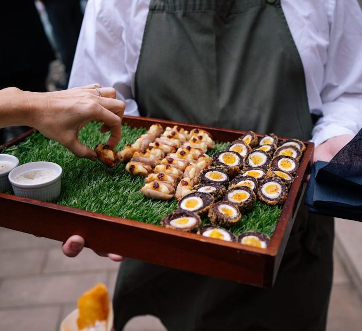 Canapes at industrial wedding with customised neon light