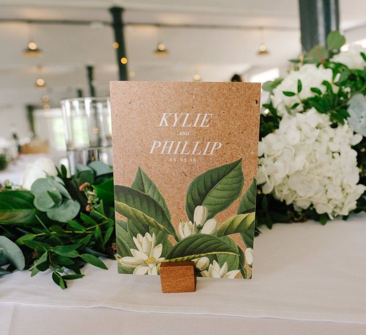 Wedding table decor with place names and white flowers