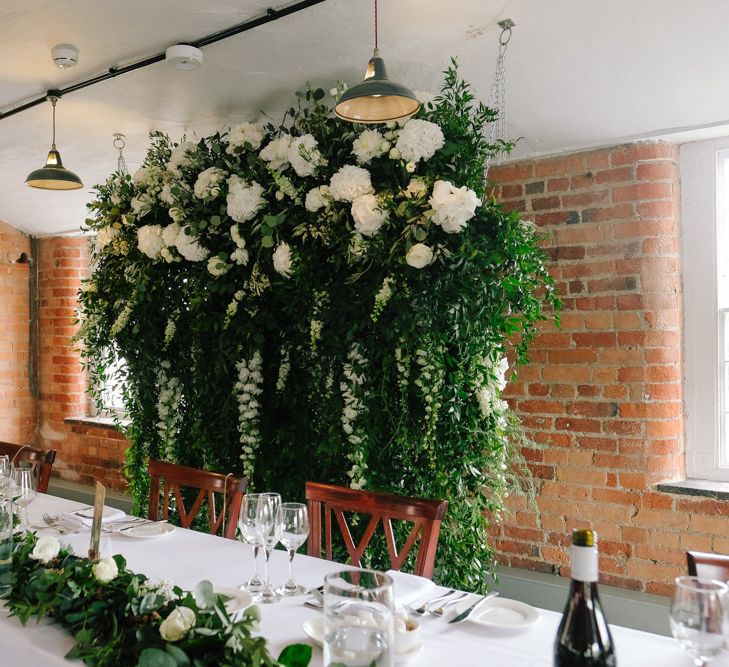 Hanging flower installation with white flowers and customised neon sign