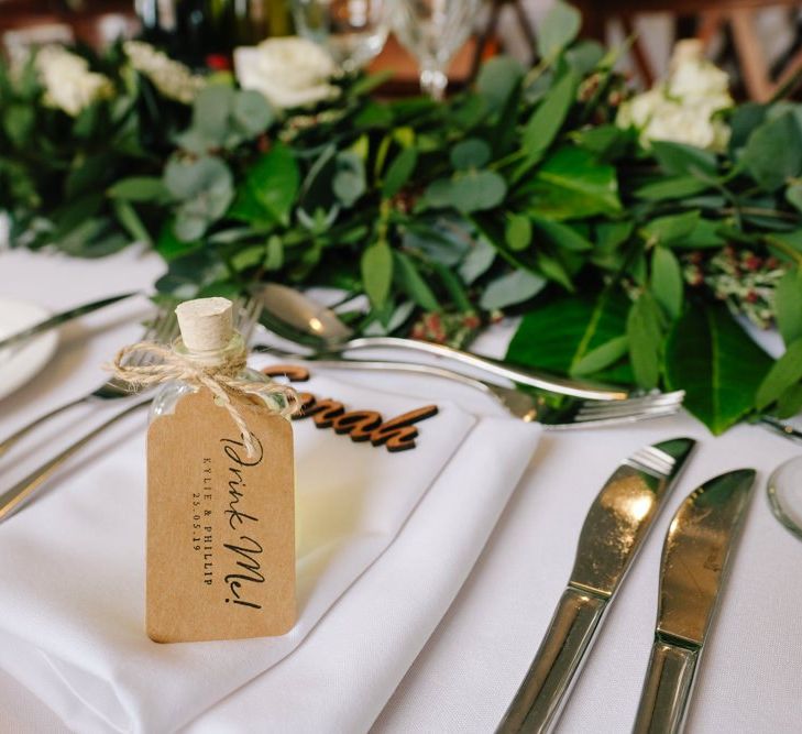 Wedding table decor with place names, wedding favours and white flowers