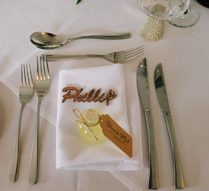 Wedding table decor with wooden place names and white flowers