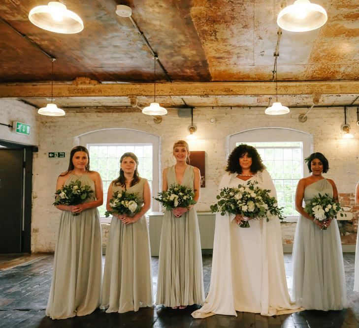 pastel green bridesmaid dresses with white wedding bouquets