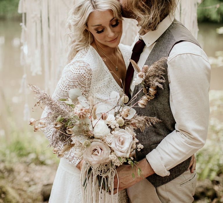 Groom in Waistcoat Kissing His Brides Forehead