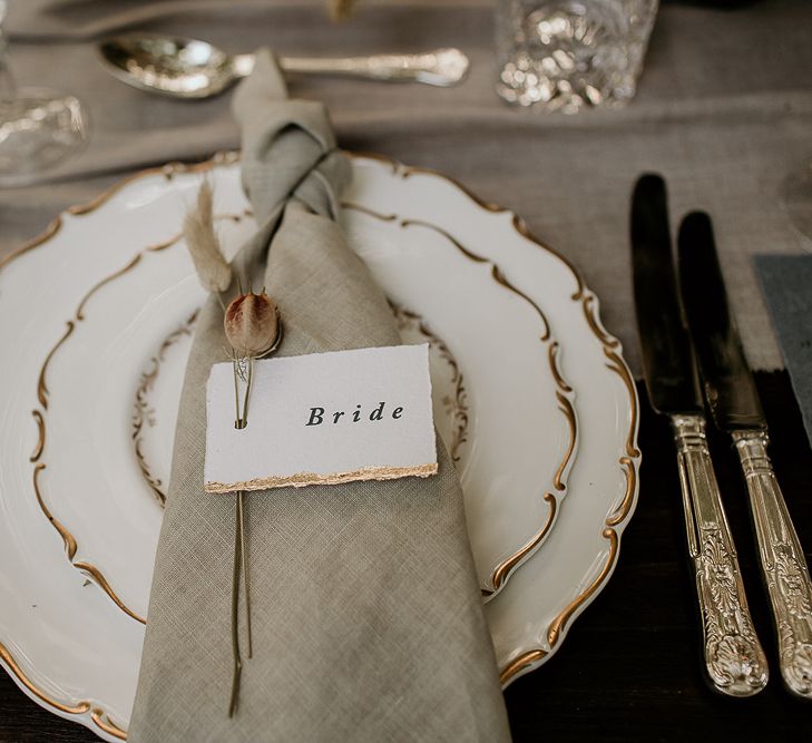 Elegant Place Setting with Ornate Tableware and Linen Napkin