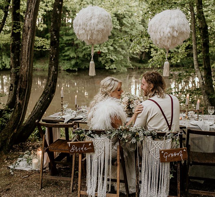 Boho Bride and Groom Sitting at Woodland Tablescape