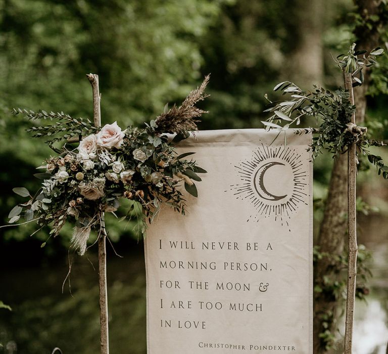 Flag Wedding Sign on Wooden Stand Decorated with Flowers