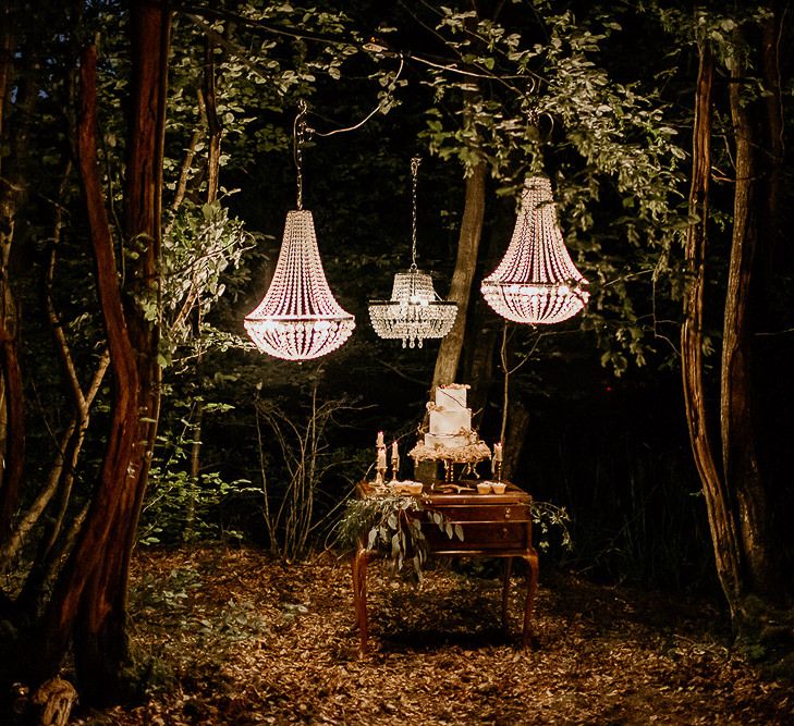 Cake Display Table on Vintage Dresses Under Hanging Chandeliers