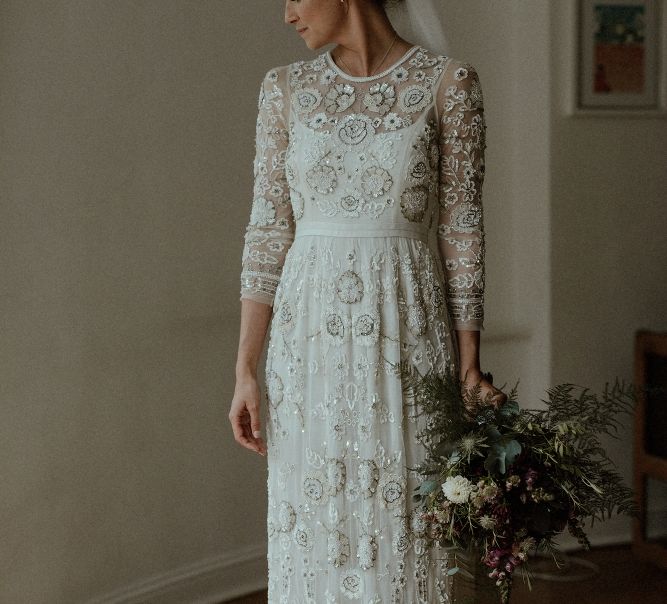 Beaded Needle &amp; Thread Wedding Dress with Long Sleeves | Maroon and White Bridal Bouquet with Green Foliage | Beaded Needle &amp; Thread Dress for Intimate Islington Wedding | Olivia &amp; Dan Photography