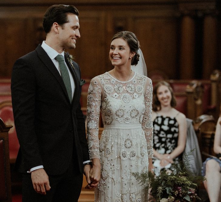 Wedding Ceremony | Bride in Beaded Needle &amp; Thread Wedding Dress with Long Sleeves | Groom in Marks &amp; Spencer Suit with Olive Tie | Britten Veil | Maroon and White Bridal Bouquet with Green Foliage | Islington Town Hall | Beaded Needle &amp; Thread Dress for Intimate Islington Wedding | Olivia &amp; Dan Photography