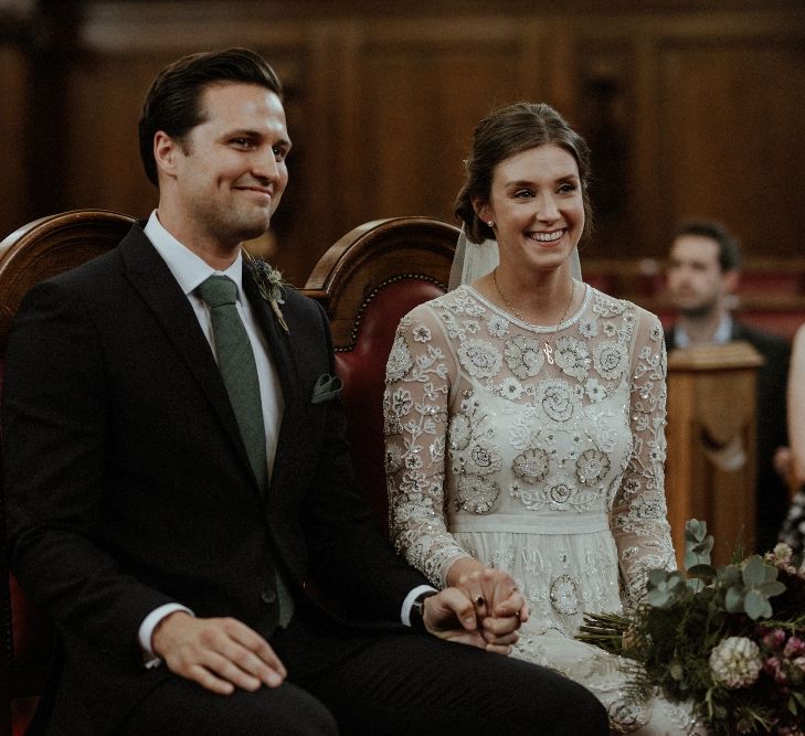 Wedding Ceremony | Bride in Beaded Needle &amp; Thread Wedding Dress with Long Sleeves | Groom in Marks &amp; Spencer Suit with Olive Tie | Britten Veil | Maroon and White Bridal Bouquet with Green Foliage | Islington Town Hall | Beaded Needle &amp; Thread Dress for Intimate Islington Wedding | Olivia &amp; Dan Photography