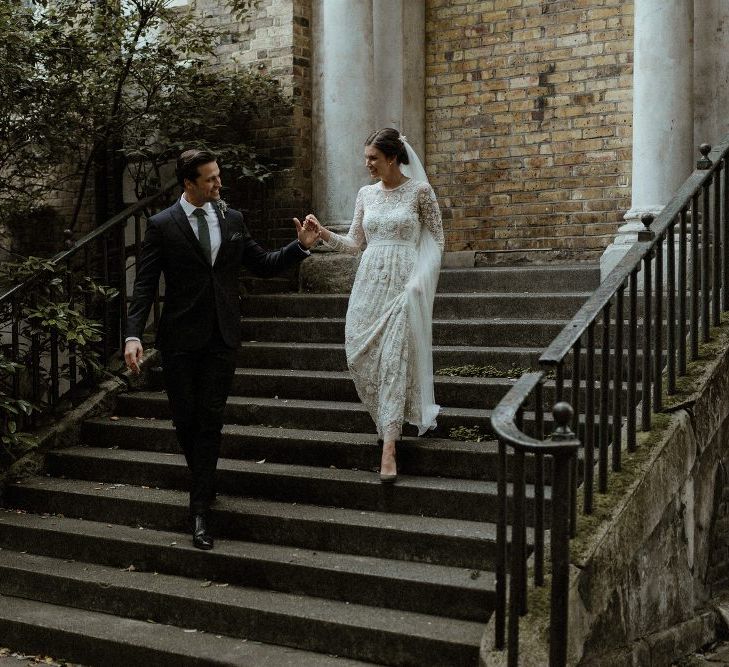 Bride in Beaded Needle &amp; Thread Wedding Dress with Long Sleeves | Groom in Marks &amp; Spencer Suit with Olive Tie | Britten Veil | Tania Maris Hairpiece | Olive Green Sergio Rossi Shoes | Beaded Needle &amp; Thread Dress for Intimate Islington Wedding | Olivia &amp; Dan Photography