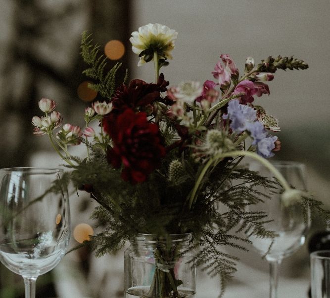 Wedding Reception Decor | Maroon and White Table Flowers with Thistles and Foliage in Mason Jars | Bourne &amp; Hollingsworth Buildings | Greenhouse Reception Venue | Beaded Needle &amp; Thread Dress for Intimate Islington Wedding | Olivia &amp; Dan Photography