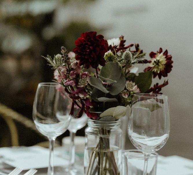 Wedding Reception Decor | Maroon and White Table Flowers with Thistles and Foliage in Mason Jars | Bourne &amp; Hollingsworth Buildings | Greenhouse Reception Venue | Beaded Needle &amp; Thread Dress for Intimate Islington Wedding | Olivia &amp; Dan Photography