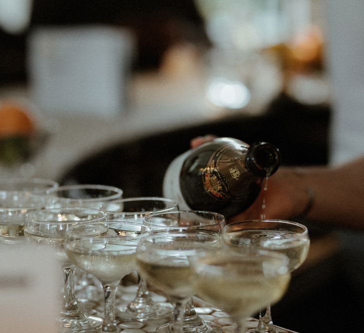 Wedding Reception | Champagne Served in Coupe Glasses | Bourne &amp; Hollingsworth Buildings | Beaded Needle &amp; Thread Dress for Intimate Islington Wedding | Olivia &amp; Dan Photography