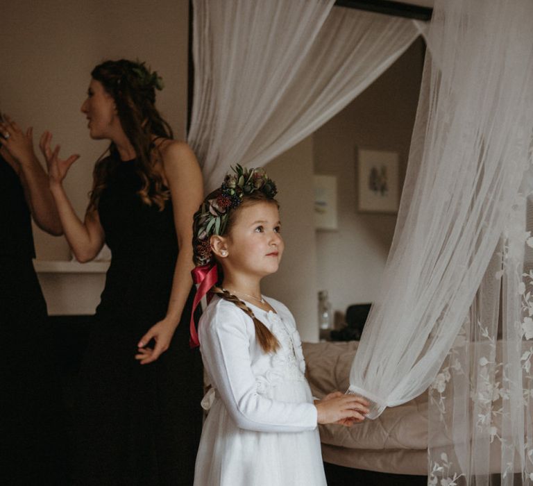 Flower girl in white dress with flower crown