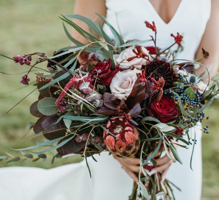 Red flower and foliage bouquet for bride to match supermarket wedding cake floral decor