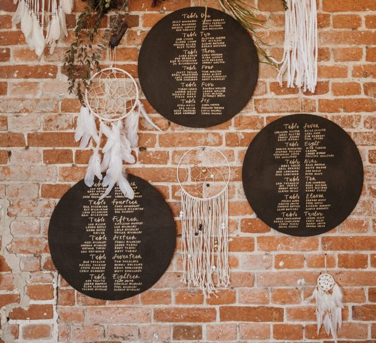 Chalkboard seating charts with dream catcher wedding decor