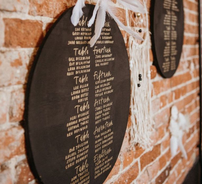 Chalkboard seating charts with dream catcher wedding decor