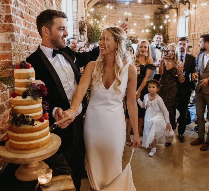 Bride and groom cut the supermarket wedding cake