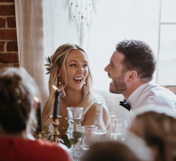 Bride and groom enjoy wedding speeches