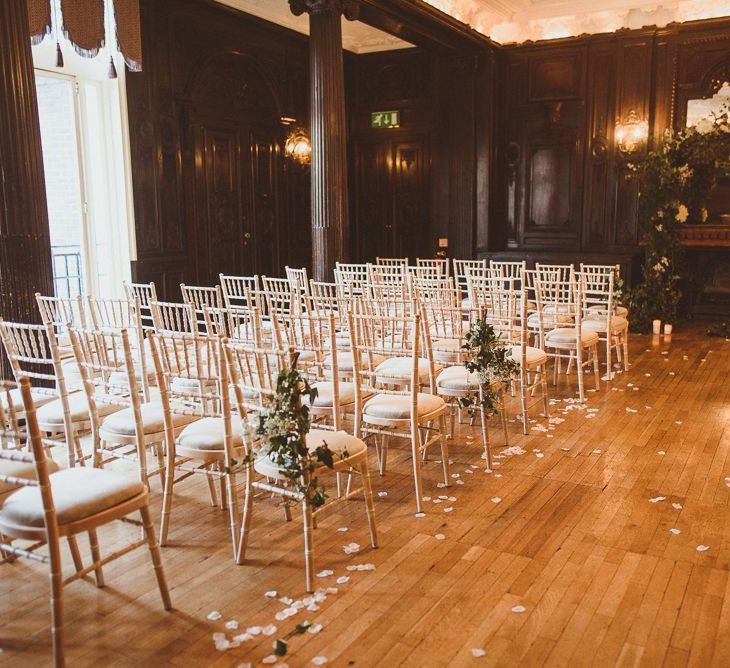 Reception styling with white foliage arch decor and pillar candles