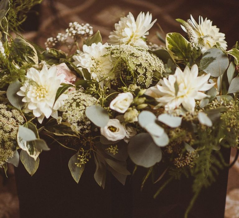 Silver embellished bridal shoes with white foliage bouquet