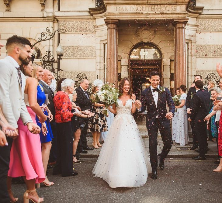 Confetti shot outside of Dartmouth House with bride wearing beautiful Martina Liana dress