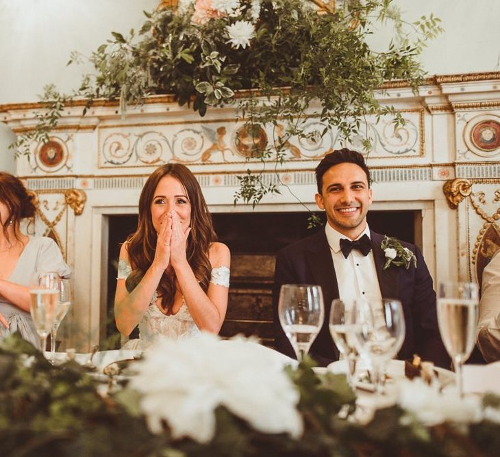 Bride and groom at the top table with beautiful white foliage decor