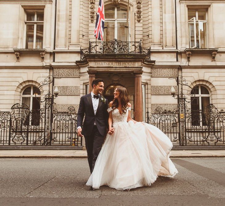 Bride and groom steal a moment wearing Martina Liana dress at Dartmouth House in London