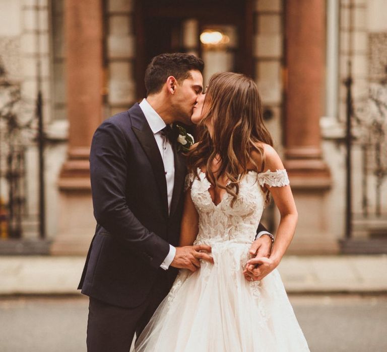 Bride wearing off the shoulder laced dress with tulle skirt