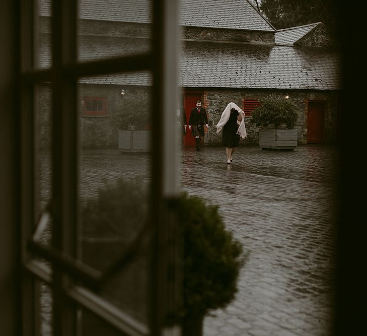 Wedding Guests Walking Through Larchfield Estate Courtyard