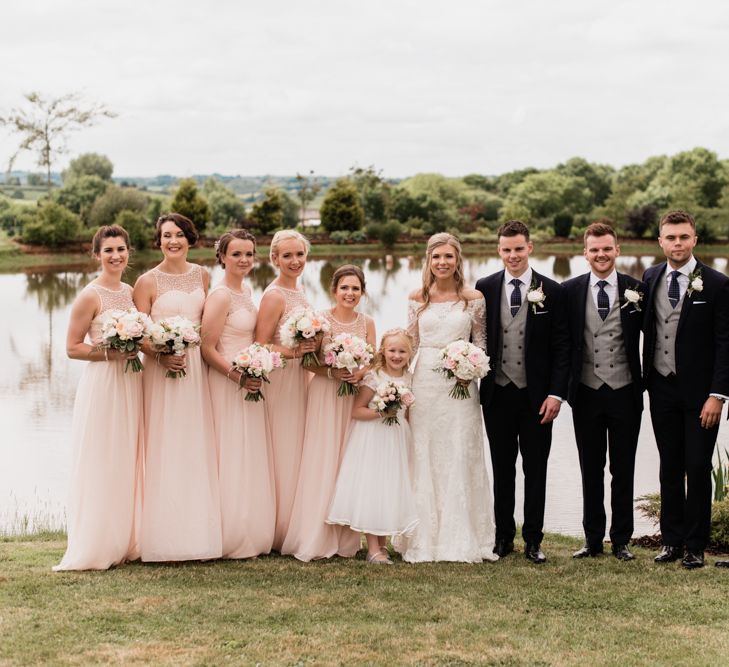 Wedding Party Portrait with Bridesmaids in Pink and Groomsmen in Black and Grey Suits