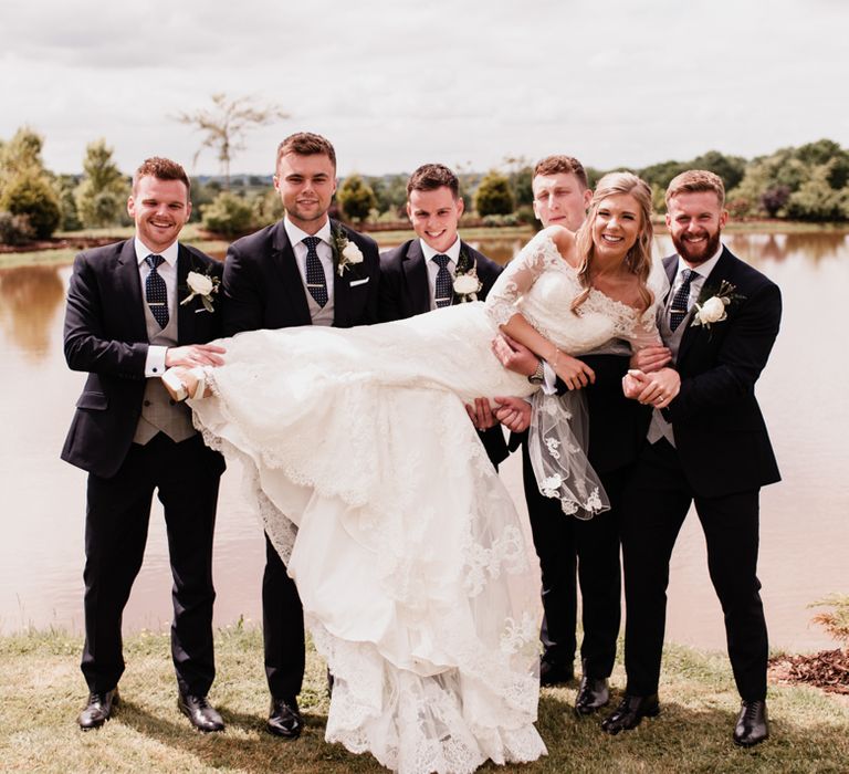 Groomsmen Holding Up the Bride in a Lace Wedding Dress