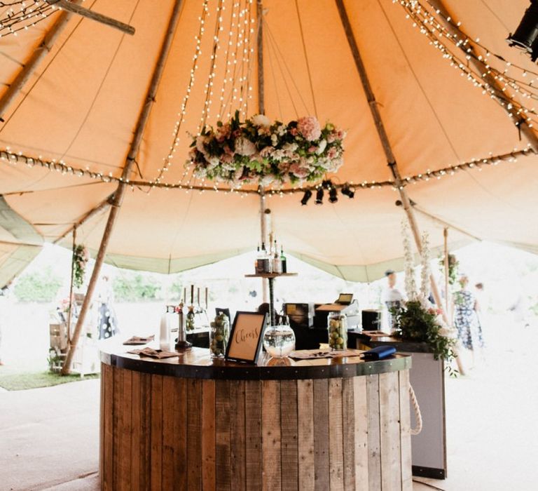 Wooden Bar with Floral Chandelier in Tipi Reception