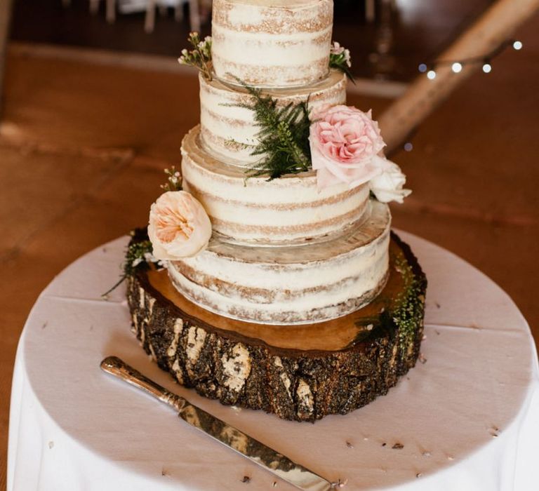 Four Tier Semi Naked Wedding Cake with Flower and Cake Topper Decor