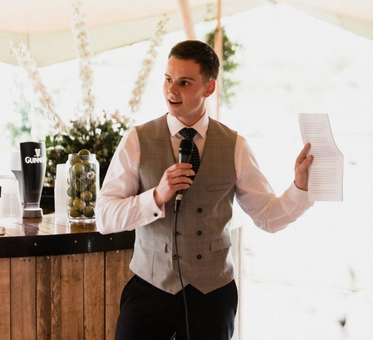 Groom in Navy Trousers and grey Waistcoat Giving His Wedding Speech