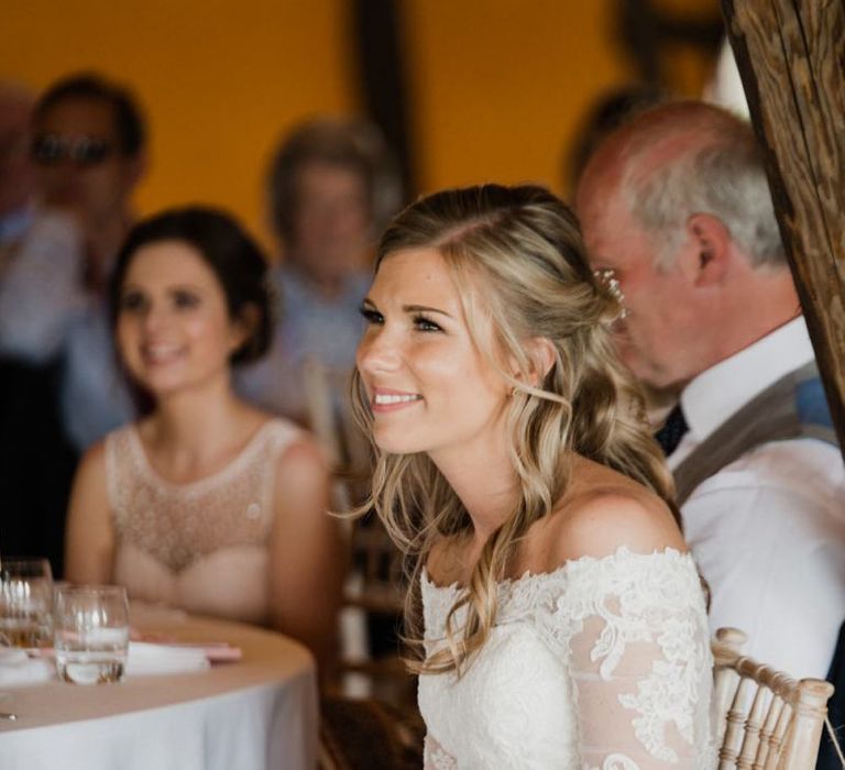 Bride in Lace Off The Shoulder Wedding Dress Enjoying the Wedding Speeches