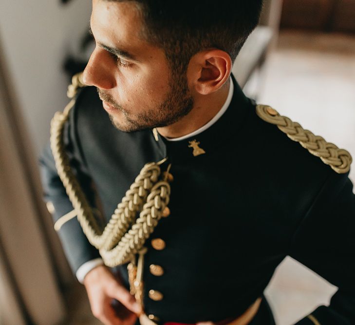 Groom wears traditional uniform for military wedding