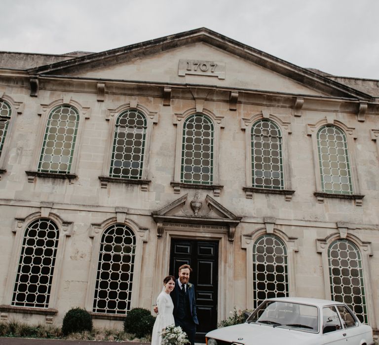 Bride and Groom Standing Outside Rook Lane Wedding Venue in Somerset