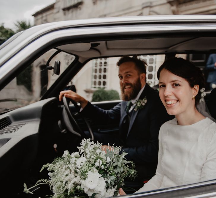 Bride and Groom Driving Off in Vintage BMW Wedding Car