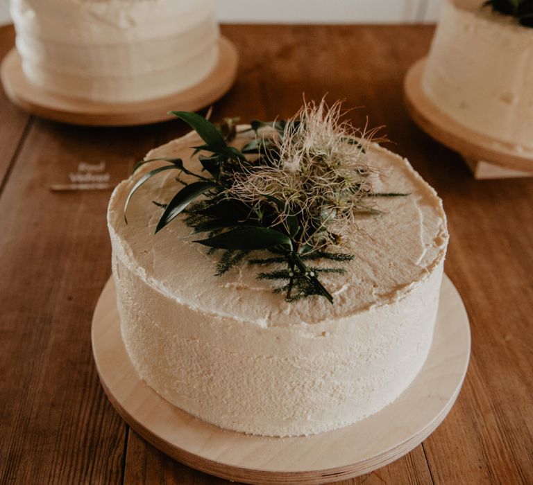 Three Single Tier Wedding Cakes with Green and White Wedding Flower Toppers